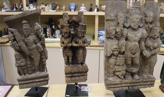 Three Middle Eastern wood carvings, on stand tallest 60cm